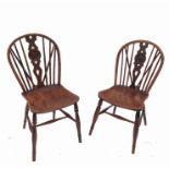 A set of six Windsor dining chairs, with bell push wheel back within a pierced vase splat,