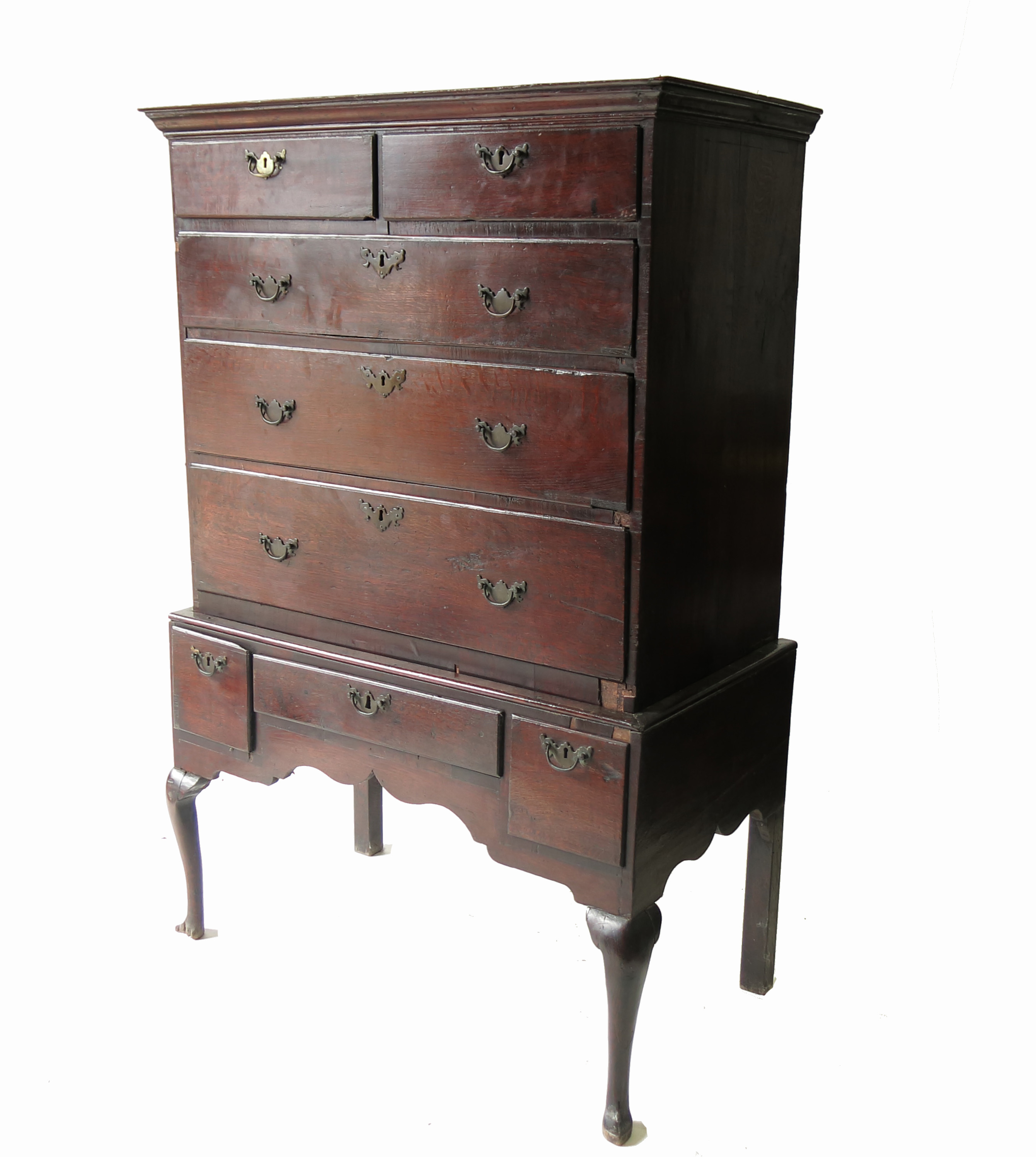 An Antique oak chest on stand, the upper section fitted two short over three long graduated drawers,