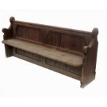 A 19th century oak framed pew, with shaped ends,