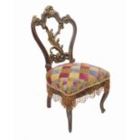 A 19th century continental parcel gilt salon chair, the shaped back with stylised leaf decoration,