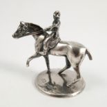 A silver model, of a racehorse and jockey, on a silver circular base, Birmingham 1906,