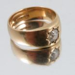 An 18 carat gold gentleman's gypsy ring, set with a single diamond solitaire of approximately 0.