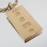 A 9 carat gold ingot, with engraved decoration,