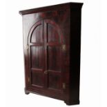 A Georgian mahogany corner cupboard,