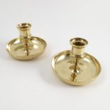 A pair of 19th century brass Brighton Bun candlesticks, of circular form,