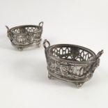 A pair of Victorian silver open salts, the oval salts having pierced sides decorated with swags,