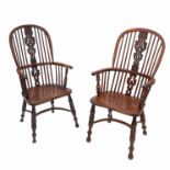 A near pair of yew wood high back Windsor armchairs, with a pierced central vase splat,
