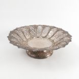 A pierced silver pedestal dish, decorated with pierced panels framed by embossed scroll,