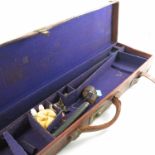 A leather covered motor gun case, of rectangular form, with brass corners and straps,