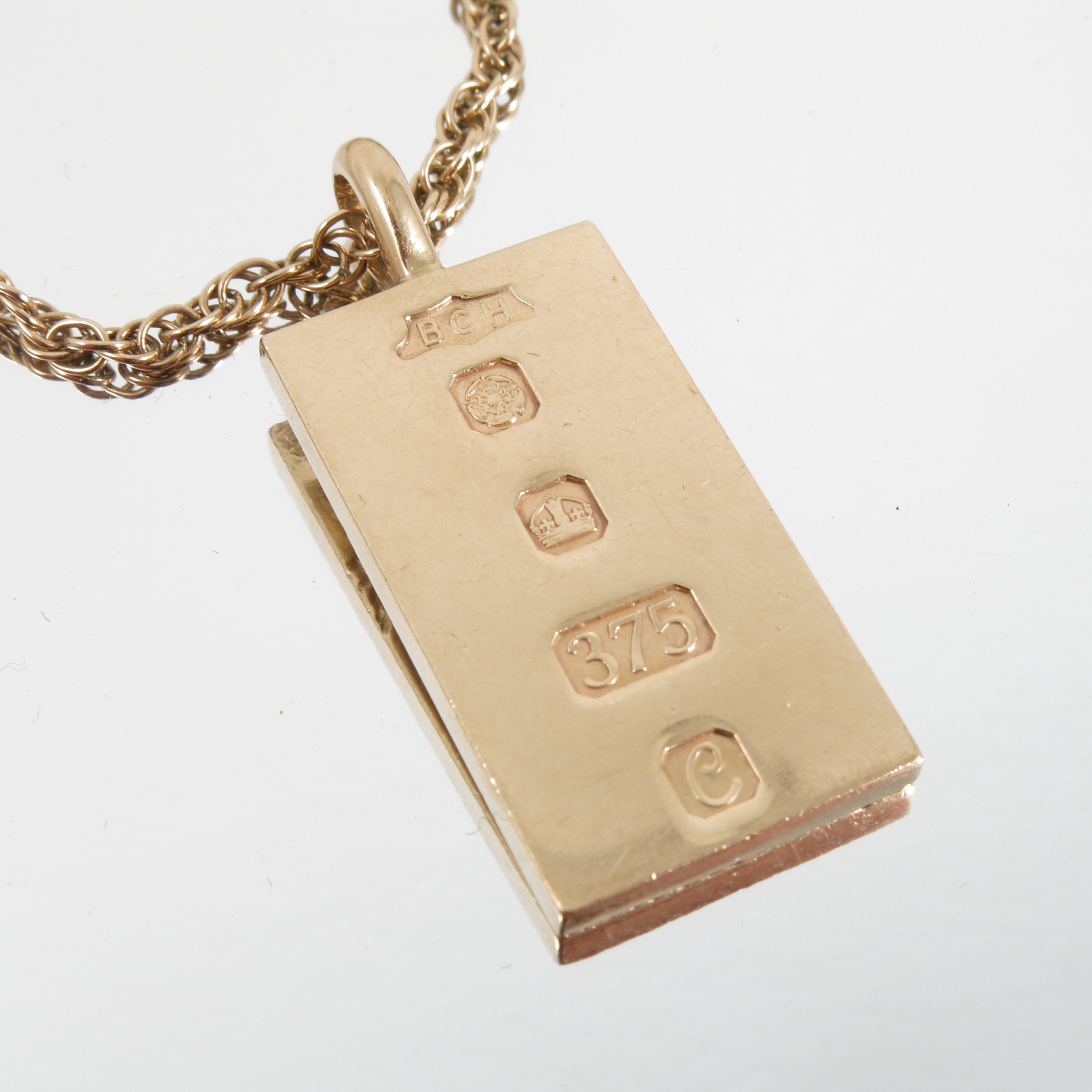 A 9 carat gold ingot, with engraved decoration, - Image 2 of 4