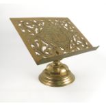 A brass lectern, the pierced rectangular stand raised on a turned column and circular base,