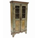 An American painted pine cupboard, with grilled and panelled doors,
