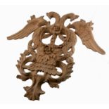 A decorative carved wooden wall hanging, carved with two HoHo birds and foliage,