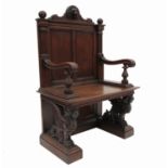 A pair of 19th century oak throne chairs, with a lion's mask frieze flanked by two reeded balls,