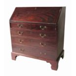 A Georgian mahogany bureau, the fall flap opening to reveal drawers, cupboards and pigeon holes,