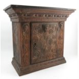 An Antique oak wall cupboard, the whole carved in the 16th century style, with masks,