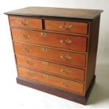An Edwardian ebonised and pine chest, of two short over four long graduated drawers,