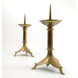 A pair of brass pricket candlesticks, raised on a triform base, with three shaped feet,