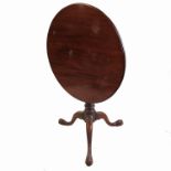 A late Georgian mahogany circular occasional table, raised on a tripod base with birdcage movement,