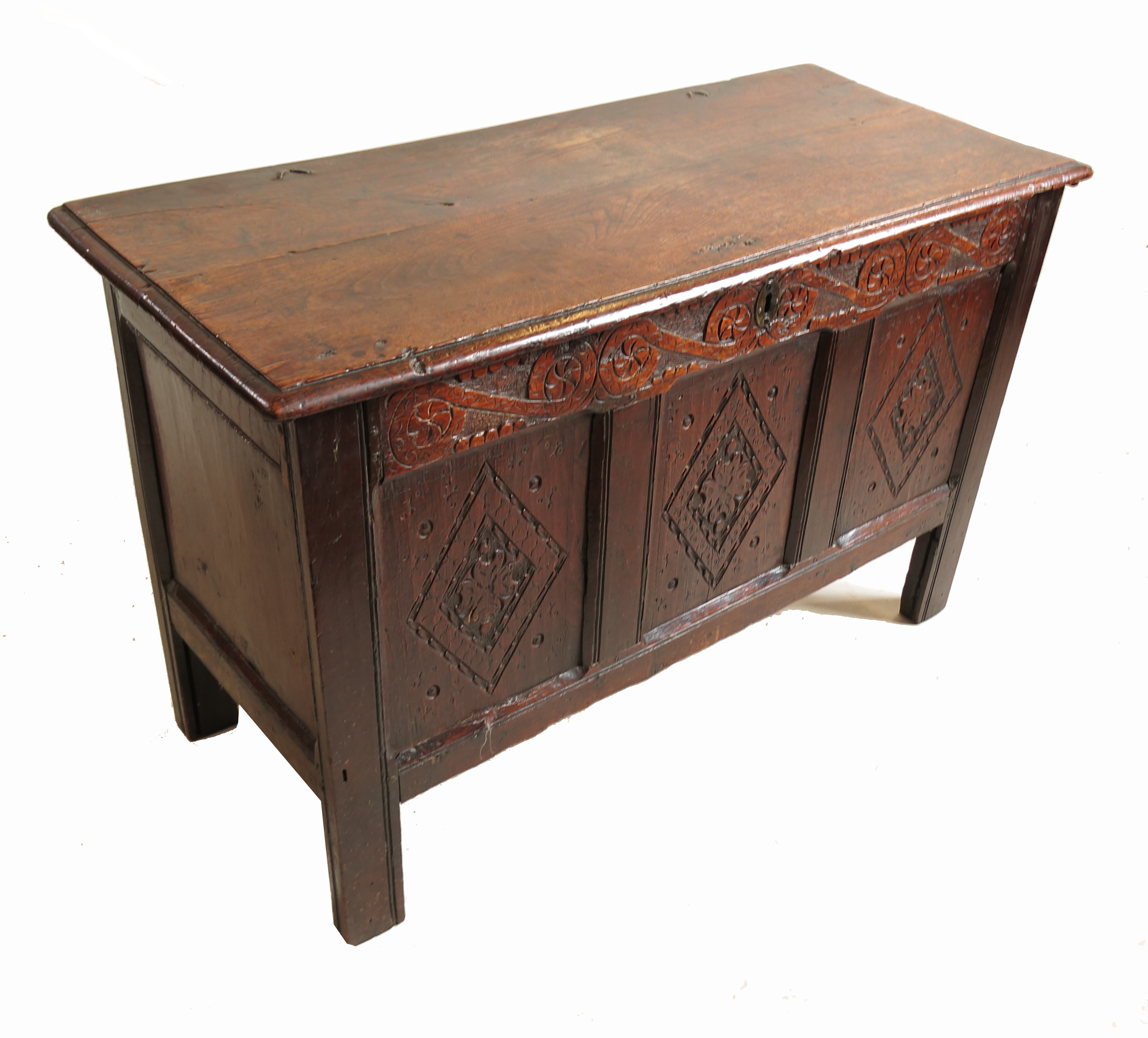 An Antique oak coffer, with three carved panels to the front, below a plain rising lid,