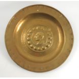 An antique brass alms dish, in the 17th Century Nuremberg style,