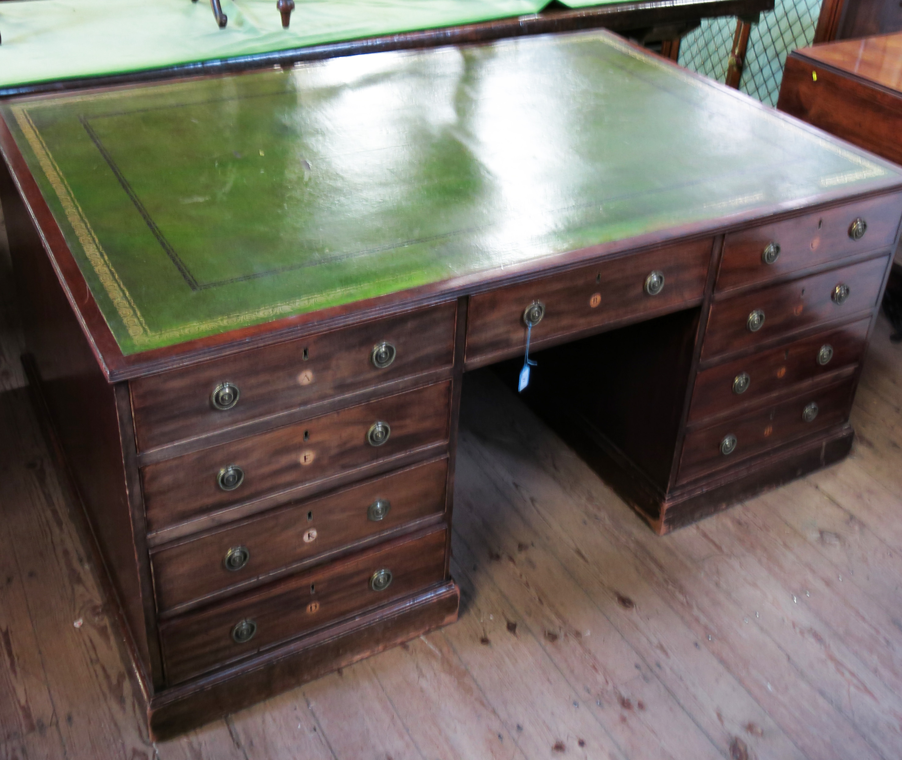 An antique mahogany estate partners desk, fitted with an arrangement of drawers to each side,