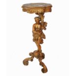 An antique gilt torchere, in the form of a semi-draped man, raised on three scroll feet, height 36.