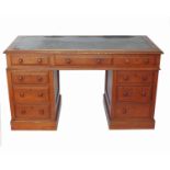 A Victorian oak desk, fitted with three frieze drawers and raised on two pedestals,