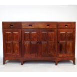 An Arts and Crafts break front cabinet, possibly walnut,