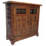 A low cupboard, with turned spindle decoration to the door fronts,