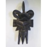 An Ivory Coast Seufu Carved Wooden Mask, stained with goat's blood when bought used in ceremony.