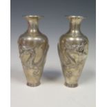 A Pair of Chinese Silver Vases decorated with dragons, the bases stamped WA and with character marks