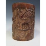 A Chinese Bamboo Bitong or Brush Pot carved with seated figures and boats in landscape, 18 cm
