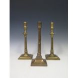 A Pair of 18th Century Gun metal Candlesticks, 26 cm and one other