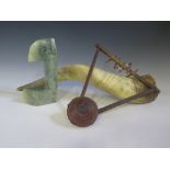 A West African Harp, cow horn and carved stone sculpture