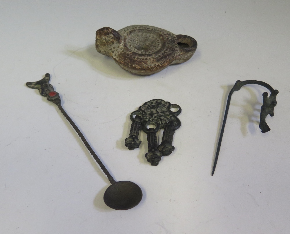 An Antique Bronze Ornamental Clothing Accessory cast with mask, cloak pin, terracotta oil lamp (