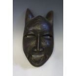 An Ivory Coast Dan or Baule Cat Mask, drilled to apply hair for ruff, 25 cm. Bought late 50's / 60'