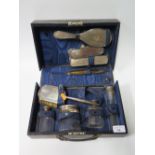 A Silver Mounted Mirror, Brush and Bottles Cased Travelling Set