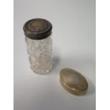 An Asprey Silver Gilt Pill Box of Oval Form marks rubbed and silver topped cut glass pot