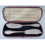 A Victorian Silver Cased Pair of Cheese Knives with chased foliate decoration, Newcastle 1835/36,