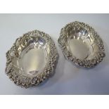 A Pair of Edward VII Silver Oval Dish, the pierced rim with repoussé foliate scroll decoration,