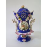 A Nineteenth Century German Porcelain Maiblumen Vase and cover with Watteau esque painted reserve,