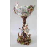 A Continental Porcelain Figural Centrepiece with floral decoration around a central tree trunk