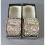 A Pair of Victorian Silver Napkins decorated with putti and scrolling foliate work, London 1900, H.B