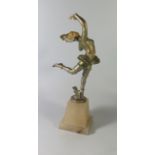 An Art Deco Painted Spelter and Ivorine Figurine of a Dancer on alabaster base, 33 cm