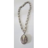 A Sterling Silver Locket on a foliate chased chain