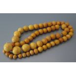 A Pressed Amber Bead Necklace, 78.1 g gross