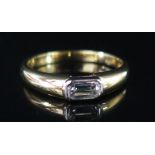 An 18ct Gold and Baguette Cut Diamond Solitaire Ring, size M.5, 3.9 g