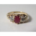 An 18ct Gold, Ruby and Diamond Three Stone Ring, size L, 3.2 g