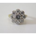 An 18ct Gold and Diamond Cluster Ring, the central stone c. 0.75ct surrounded by eight c. .12ct